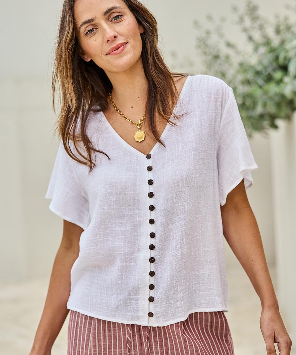 Model Tegand wearing size 10 of the Cute As A Button Blouse - White in colour White, in a cropped view