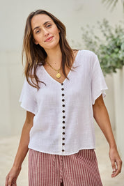 Model Tegand wearing size 10 of the Cute As A Button Blouse - White in colour White, in a cropped view