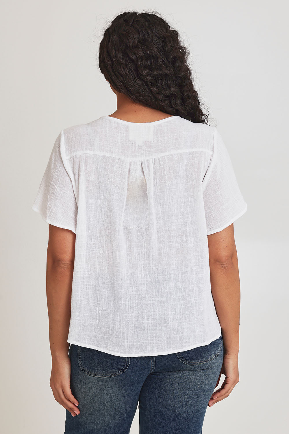 Model Terri-Leigh wearing size 14 of the Cute As A Button Blouse in colour White (White), from the back