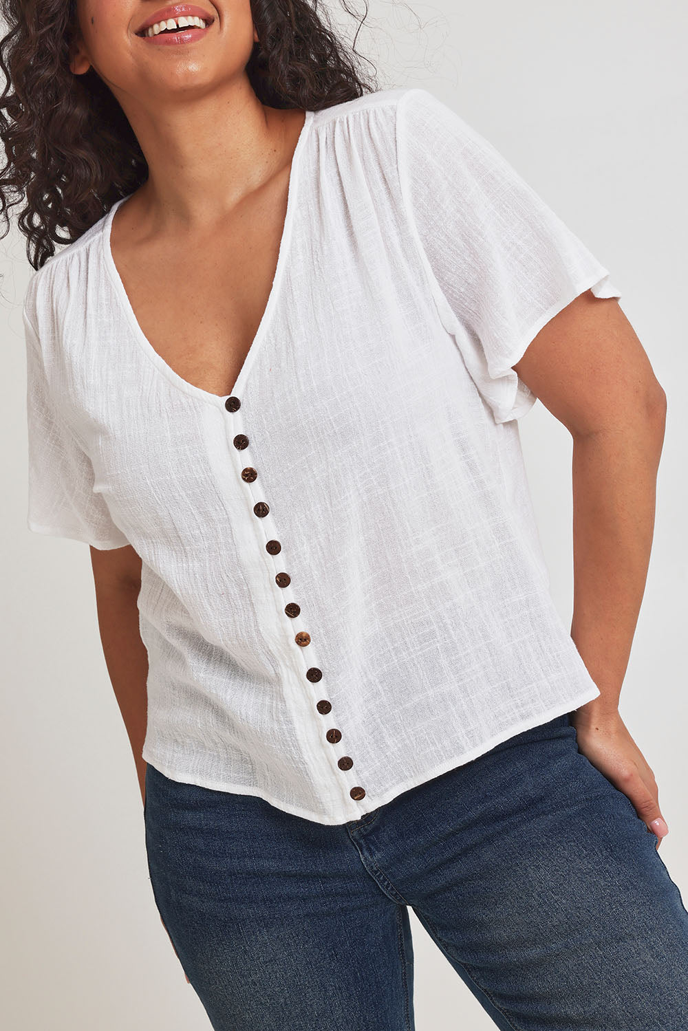Model Terri-Leigh wearing size 14 of the Cute As A Button Blouse in colour White (White), from the front, cropped image
