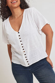 Model Terri-Leigh wearing size 14 of the Cute As A Button Blouse in colour White (White), from the front, cropped image