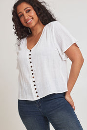 Model Terri-Leigh wearing size 14 of the Cute As A Button Blouse in colour White (White), from the front, cropped image