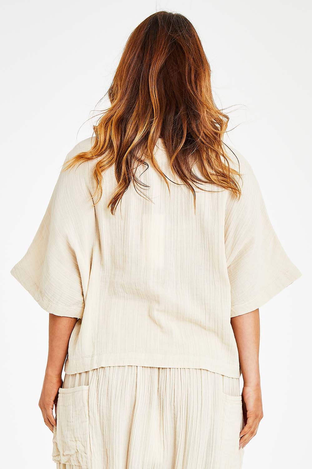 Model Laura wearing size 14 of the Beach Breeze Cotton Top in colour Wheat, from the back