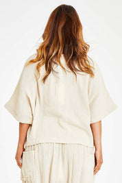 Model Laura wearing size 14 of the Beach Breeze Cotton Top in colour Wheat, from the back