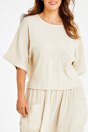 Model Laura wearing size 14 of the Beach Breeze Cotton Top in colour Wheat, from the front, cropped image