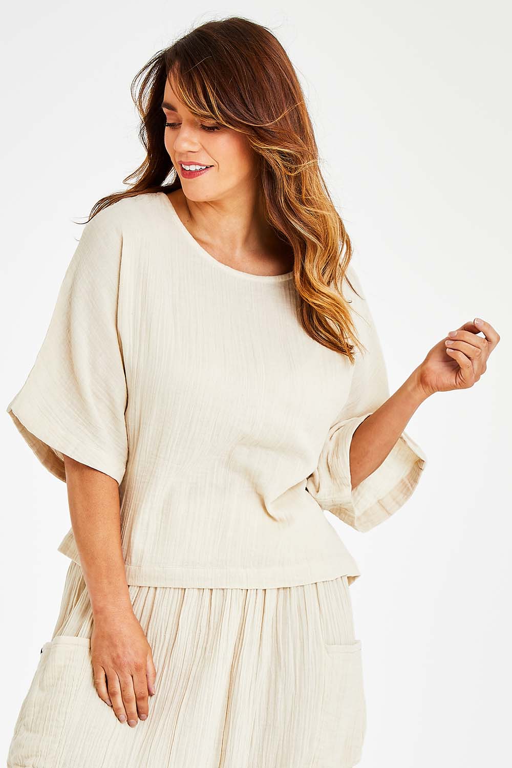 Model Laura wearing size 14 of the Beach Breeze Cotton Top in colour Wheat, from the front, cropped image