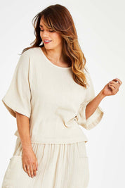 Model Laura wearing size 14 of the Beach Breeze Cotton Top in colour Wheat, from the front, cropped image