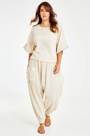 Model Laura wearing size 14 of the Beach Breeze Cotton Top in colour Wheat, from the front, showing the whole outfit