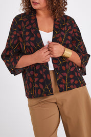 Model Anucia wearing size 14 of the You Colour My World Kimono in colour Blkfleur (Black), from the front, cropped image