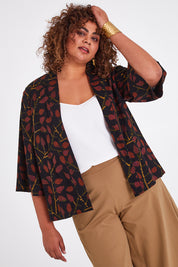 Model Anucia wearing size 14 of the You Colour My World Kimono in colour Blkfleur (Black), from the front, cropped image