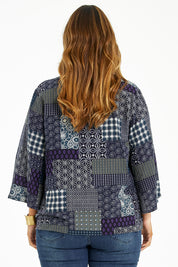 Model Laura wearing size 14 of the You Colour My World Kimono in colour Patch (Blue), from the back