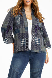 Model Laura wearing size 14 of the You Colour My World Kimono in colour Patch (Blue), from the front, cropped image