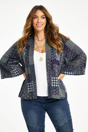 Model Laura wearing size 14 of the You Colour My World Kimono in colour Patch (Blue), from the front, cropped image