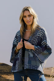 Model Tegan wearing size 10 of the You Colour My World Kimono in colour Patch (Blue), from the front, showing the whole outfit