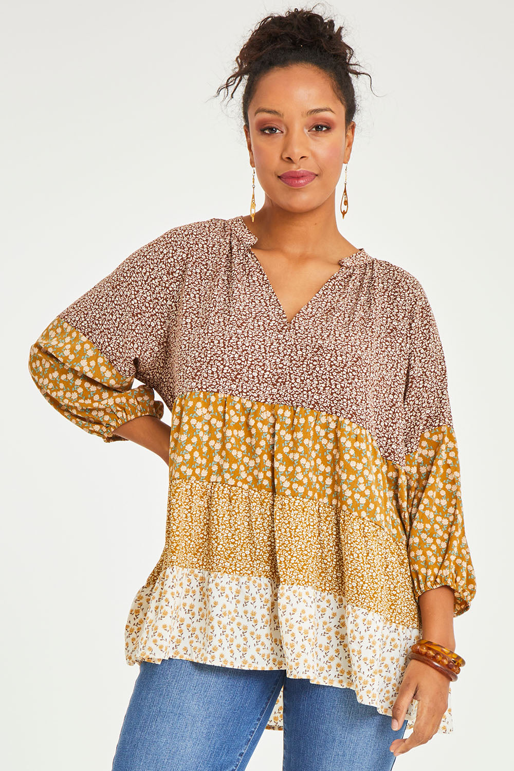 Model Noli wearing size 14 of the Cruising On By Tiered Blouse in colour Fleur, from the front, cropped image