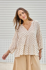 Model Tegand wearing size 10 of the Cruising On By Tiered Cotton Blouse – Chocspot in colour Chocspot, in a cropped view