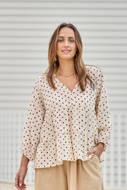 Model Tegand wearing size 10 of the Cruising On By Tiered Cotton Blouse – Chocspot in colour Chocspot, in a cropped view