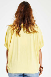 Model Laura wearing size 14 of the In My Arms Tee in colour Sunshine, from the back
