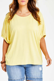 Model Laura wearing size 14 of the In My Arms Tee in colour Sunshine, from the front, cropped image