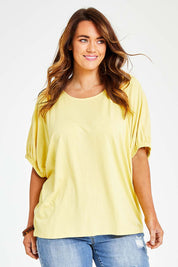 Model Laura wearing size 14 of the In My Arms Tee in colour Sunshine, from the front, cropped image