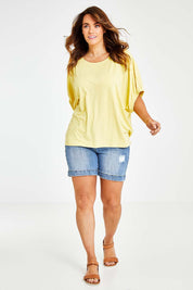 Model Laura wearing size 14 of the In My Arms Tee in colour Sunshine, from the front, showing the whole outfit