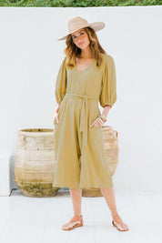 Model Ilona wearing size 10 of the A Spring In My Step Jumpsuit in colour Olive (Green), from the front, showing the whole outfit
