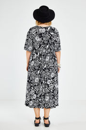 Model Jess wearing size 14 of the Swinging Hands With You Dress in colour Blackfleur (Black), from the back