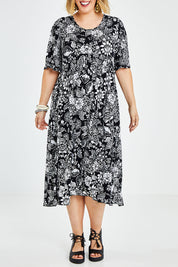 Model Jess wearing size 14 of the Swinging Hands With You Dress in colour Blackfleur (Black), from the front, cropped image