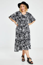 Model Jess wearing size 14 of the Swinging Hands With You Dress in colour Blackfleur (Black), from the front, showing the whole outfit