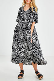 Model Kelly wearing size 10 of the Swinging Hands With You Dress in colour Blackfleur (Black), from the front, cropped image