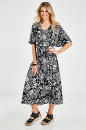 Model Kelly wearing size 10 of the Swinging Hands With You Dress in colour Blackfleur (Black), from the front, showing the whole outfit