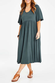 Model Laura wearing size 14 of the Swinging Hands With You Dress in colour Army (Green), from the front, cropped image