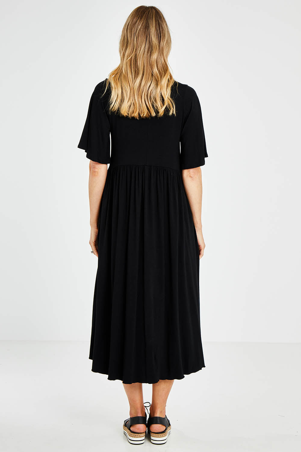 Model Kelly wearing size 10 of the Swinging Hands With You Dress in colour Black (Black), from the back
