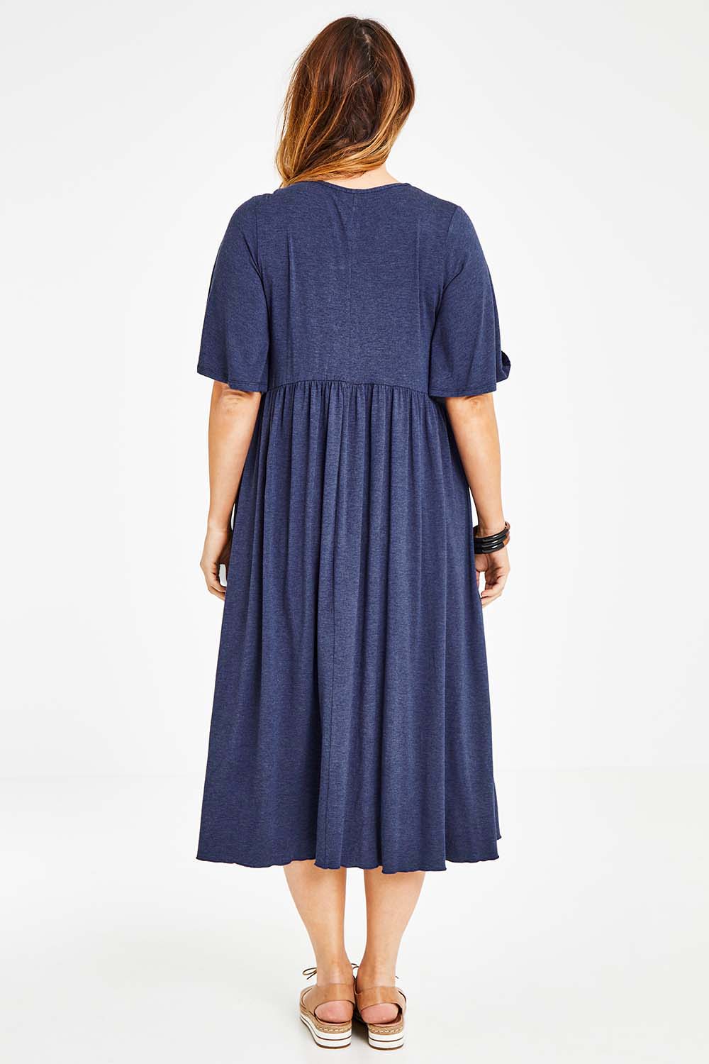 Model Laura wearing size 14 of the Swinging Hands With You Dress in colour Marldenim (Blue), from the back