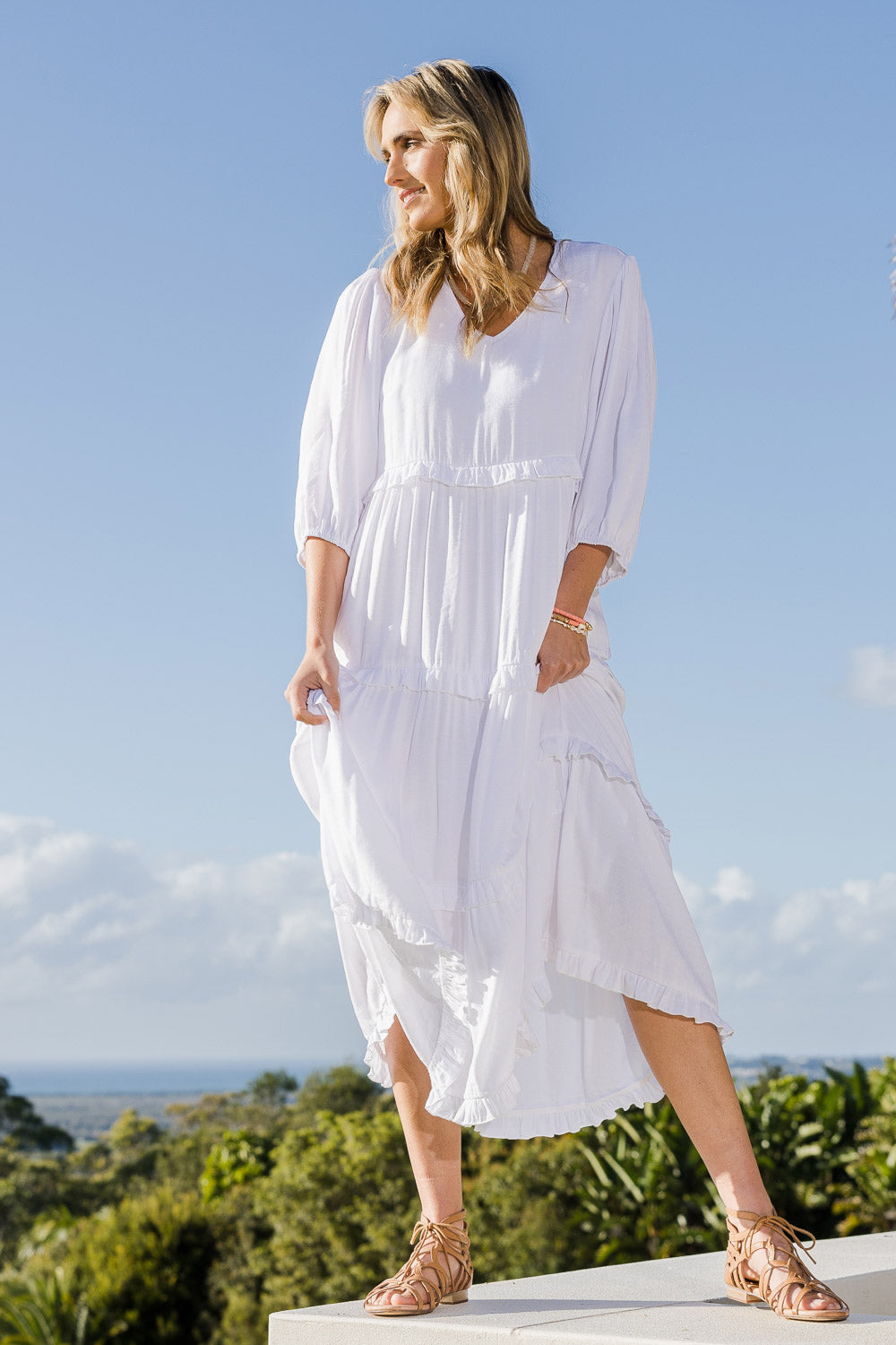 Model Tegan wearing size 10 of the Tiers Of Laughter Maxi Dress in colour White (White), from the front, showing the whole outfit