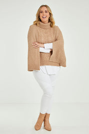 Model Jess wearing size L of the My Obsession Is You Poncho in colour Camel, from the front, showing the whole outfit