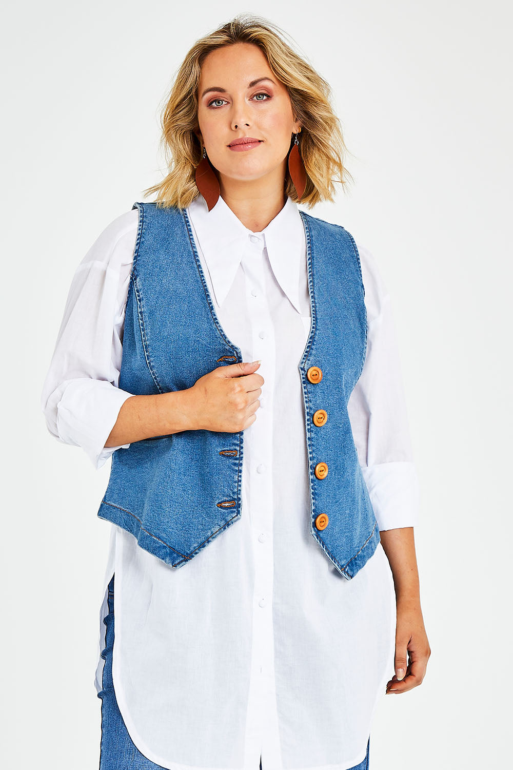 Model Jess wearing size 14 of the Fine and Dandy Denim Vest in colour Denim (Blue), from the front, cropped image