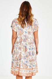 Model Laura wearing size 14 of the Floating On By You Dress in colour Coralcream, from the back