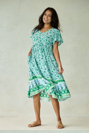 Model Tahnee wearing size 10 of the Love Shack Dress in colour Greenfleur (Green), from the front, showing the whole outfit