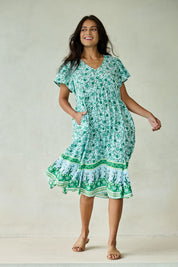 Model Tahnee wearing size 10 of the Love Shack Dress in colour Greenfleur (Green), from the front, showing the whole outfit