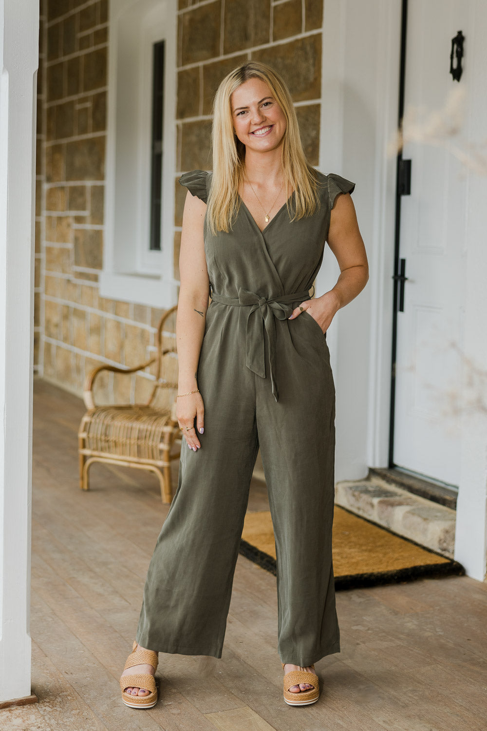 Model Bronte wearing size 10 of the I See You Jumpsuit in colour Olive (Green), from the front, showing the whole outfit