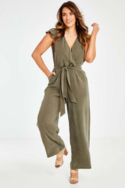Model Laura wearing size 14 of the I See You Jumpsuit in colour Olive (Green), from the front, showing the whole outfit