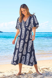 Model Tegan wearing size 10 of the You Make Me Feel Like Dancing Dress in colour Navypais (Blue), from the front, showing the whole outfit