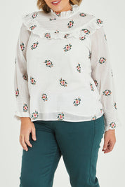 Model Fiona wearing size 16 of the Ruffle My Feathers Blouse in colour Chalk (White), from the front, cropped image
