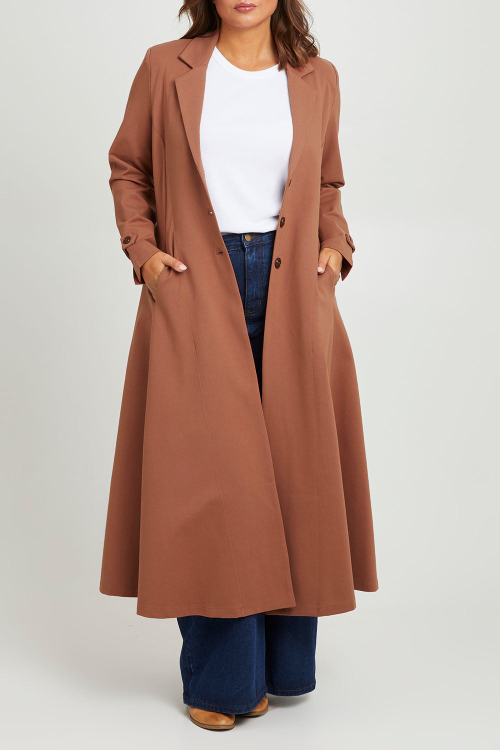 Model Monique wearing size 14 of the Meet Me At Midnight Longline Ponte Coat in colour Cinnamon, from the front, cropped image