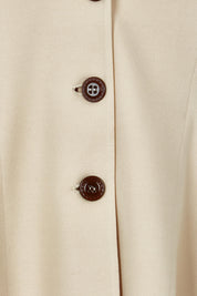 Product shot of the Meet Me At Midnight Longline Ponte Coat in colour Sand, detail