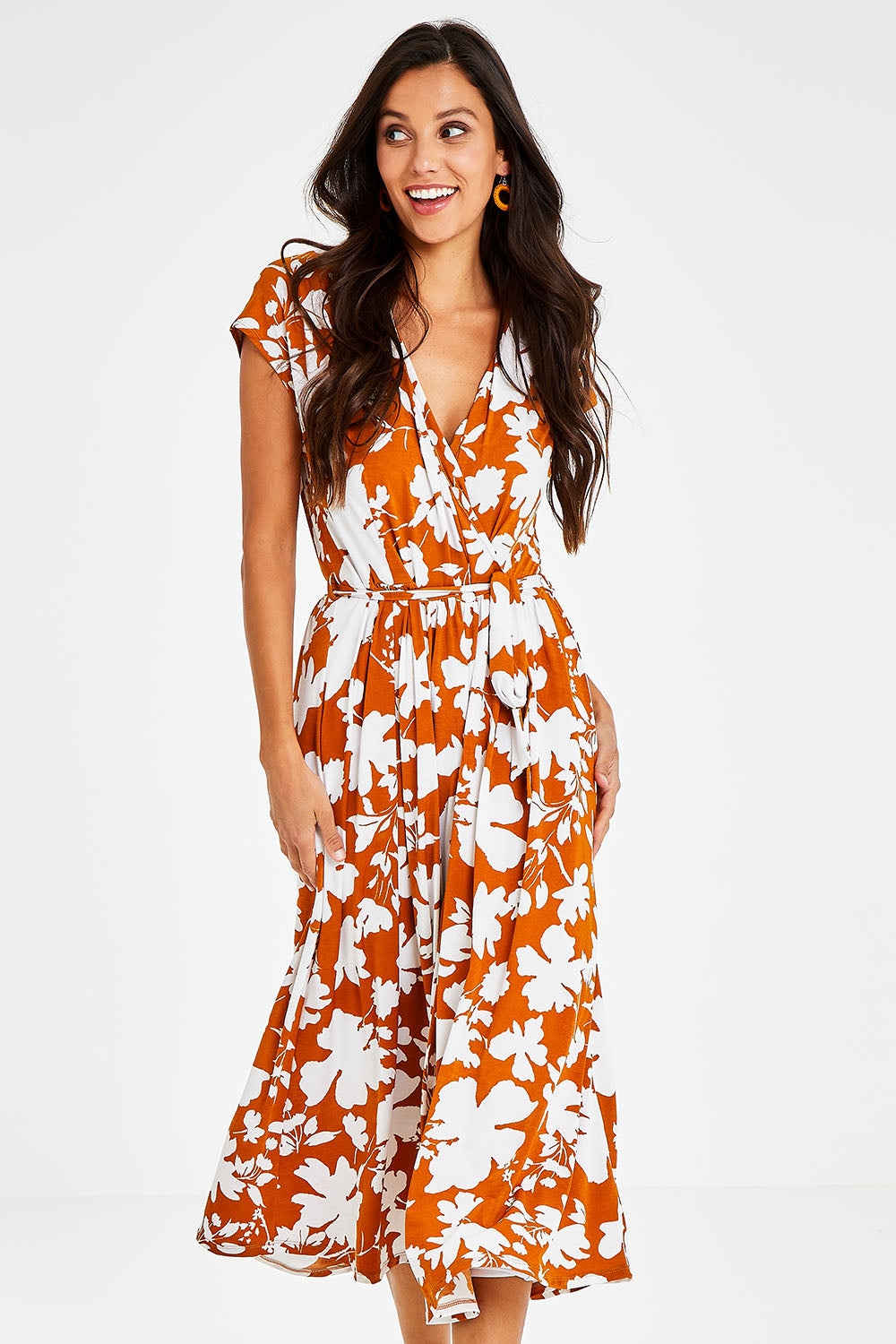 Model Vitoria wearing size 10 of the Feels Like Summer Wrap Dress in colour Rust, from the front, cropped image