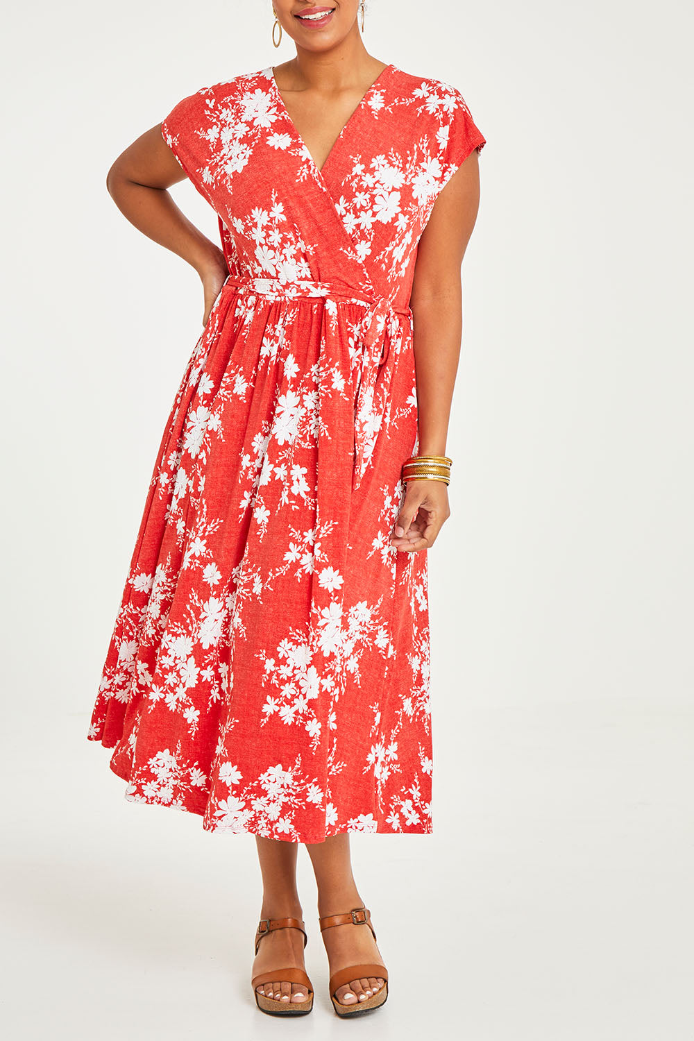 Model Noli wearing size 14 of the Feels Like Summer Wrap Dress in colour Tomato (Red), from the front, cropped image