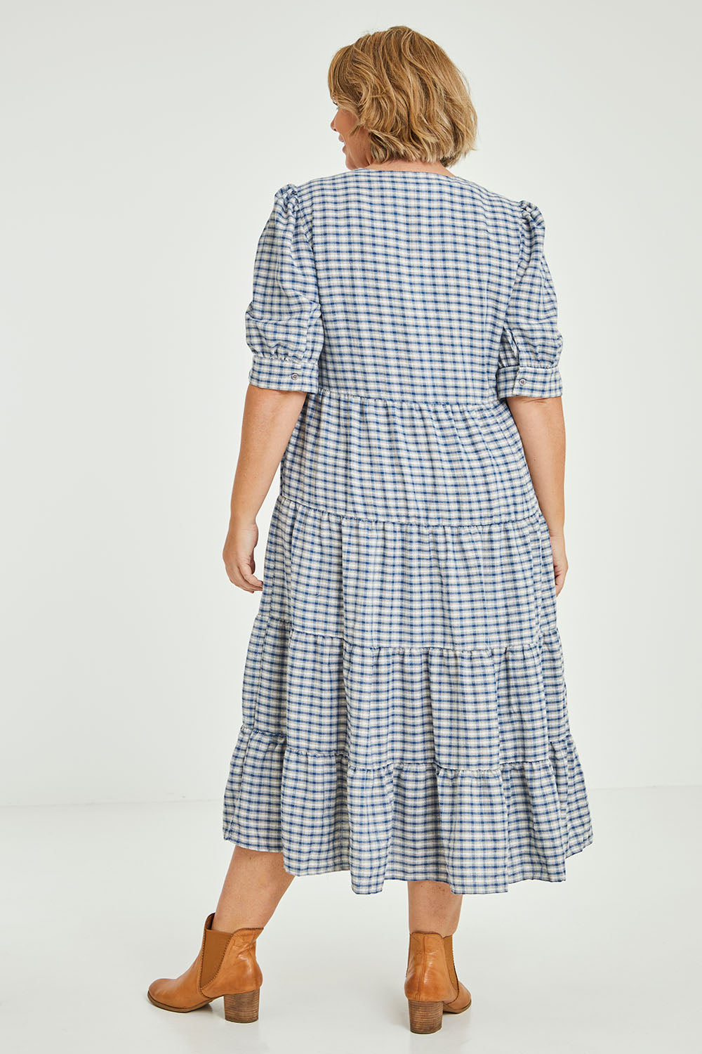 Model Fiona wearing size 16 of the Tiers Of Delight Dress in colour Bluecheck (Blue), from the back
