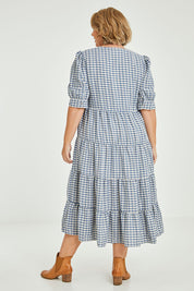 Model Fiona wearing size 16 of the Tiers Of Delight Dress in colour Bluecheck (Blue), from the back